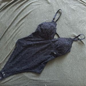 Black velvet bodysuit with open back.